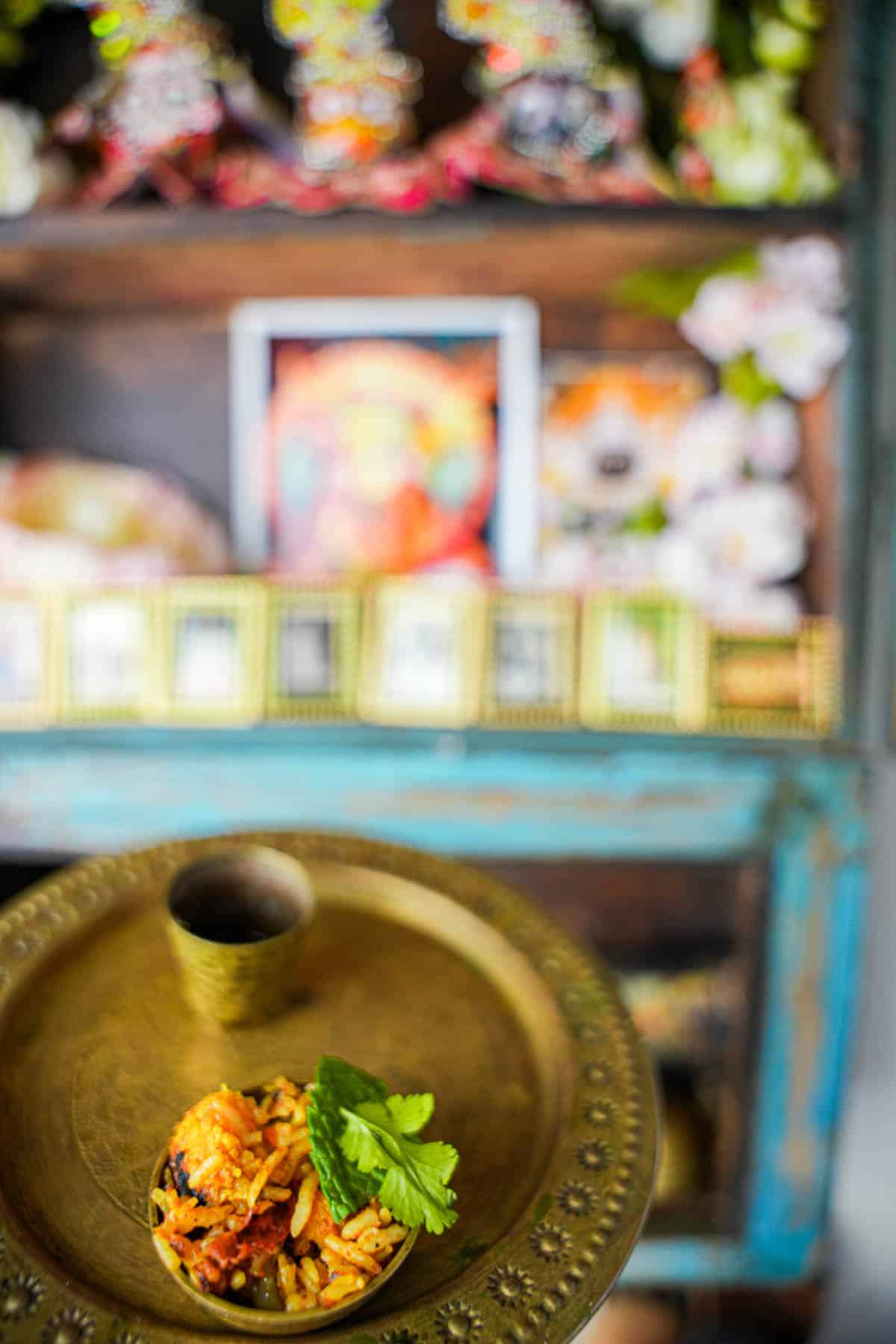 Vegan Biryani on a metal plate with a small metal cup being offered to Jagannath, Baladeva, and Subhadra. Hare Krsna!