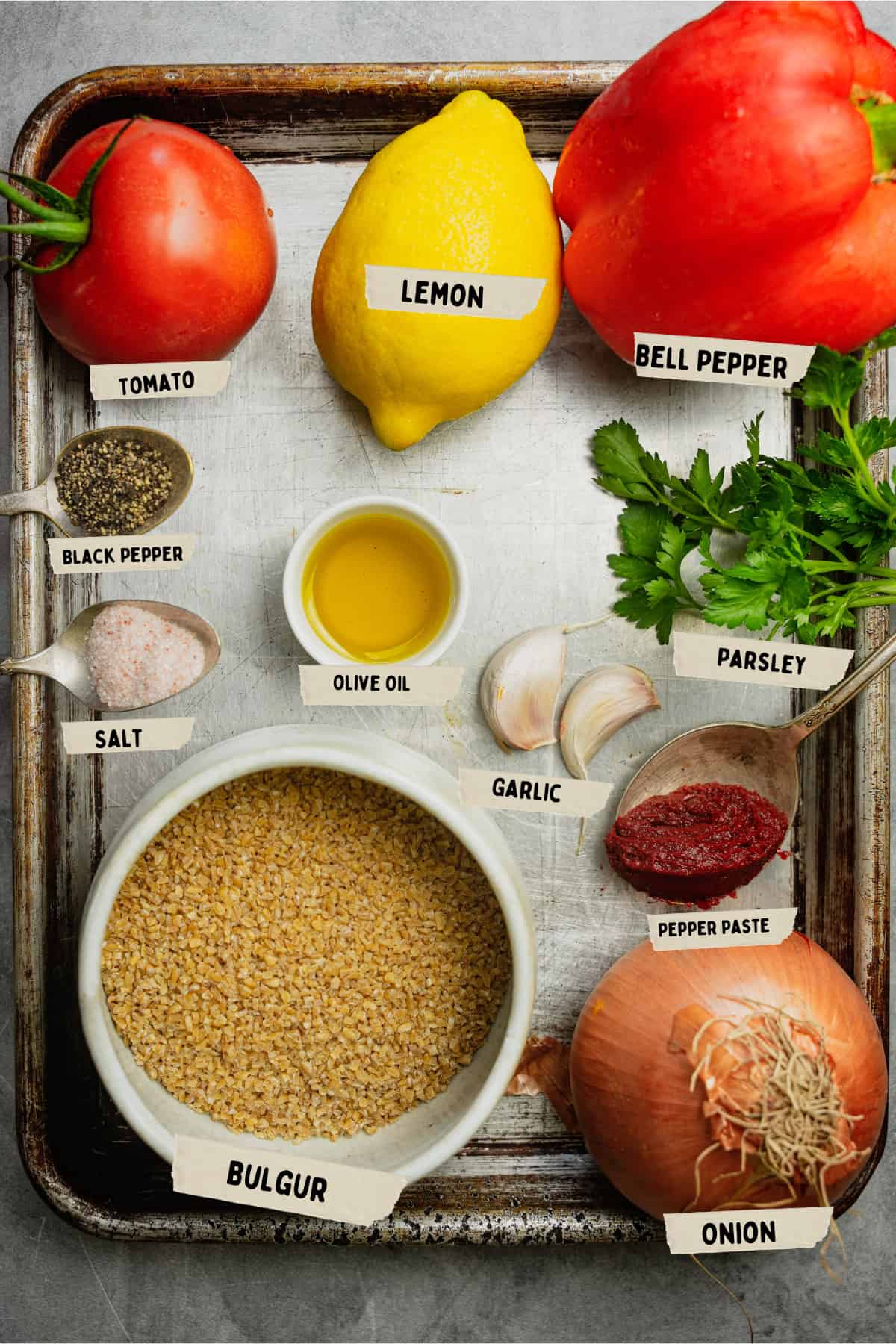 Bulgur Pilavi Ingredients are laid out and labeled on a scratched metal tray.