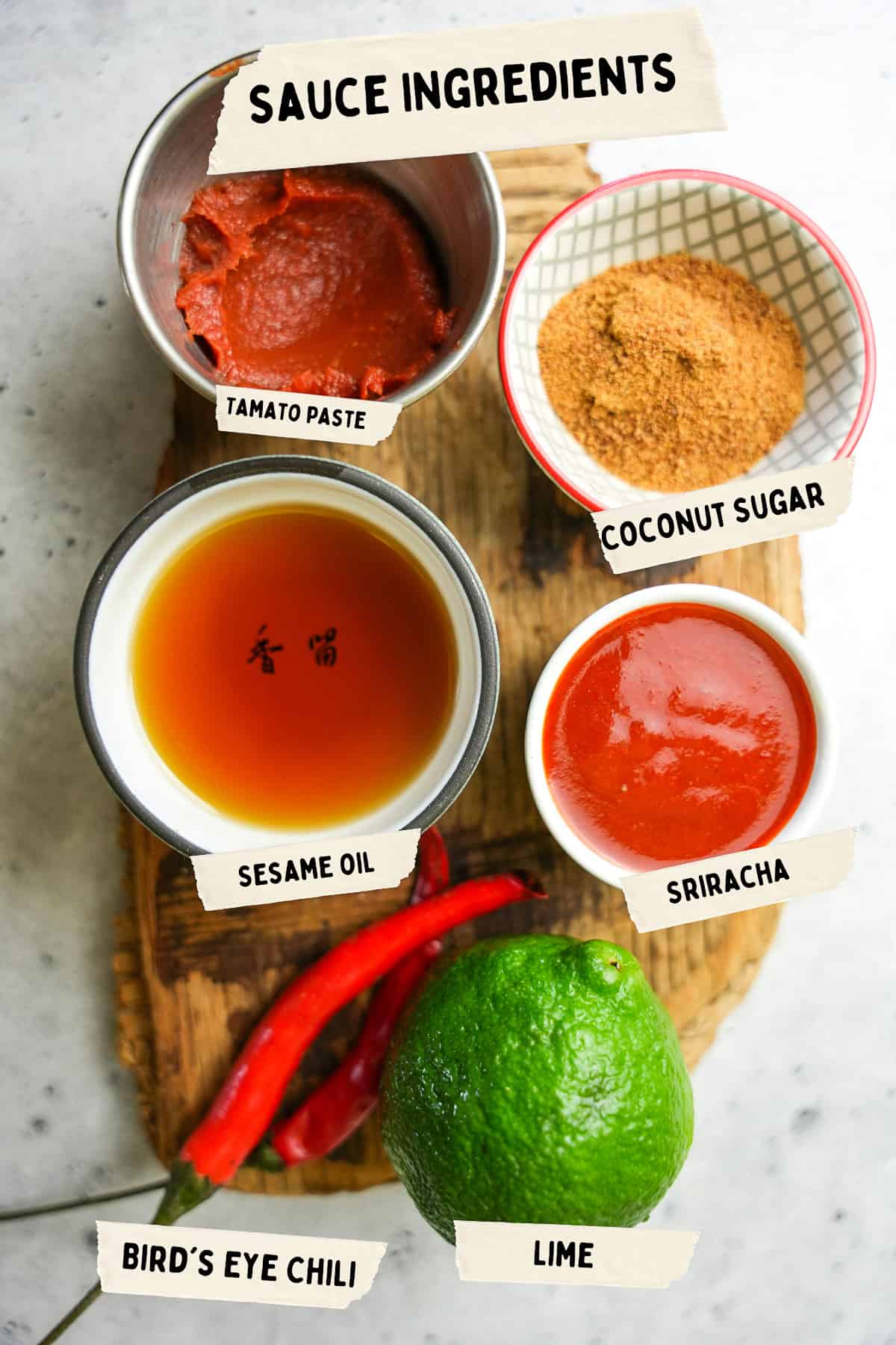 Sauce ingredients are laid out on a wooden board.