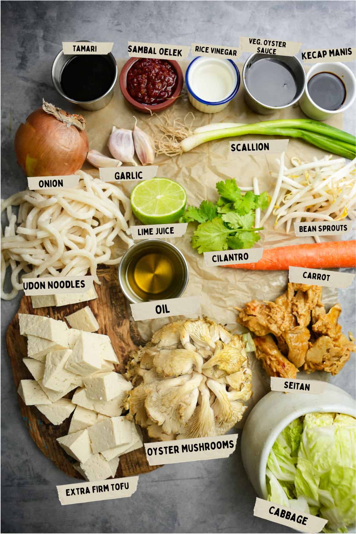 bami goreng ingredients laid out and labeled on a piece of craft paper ontop of a stone countertop.