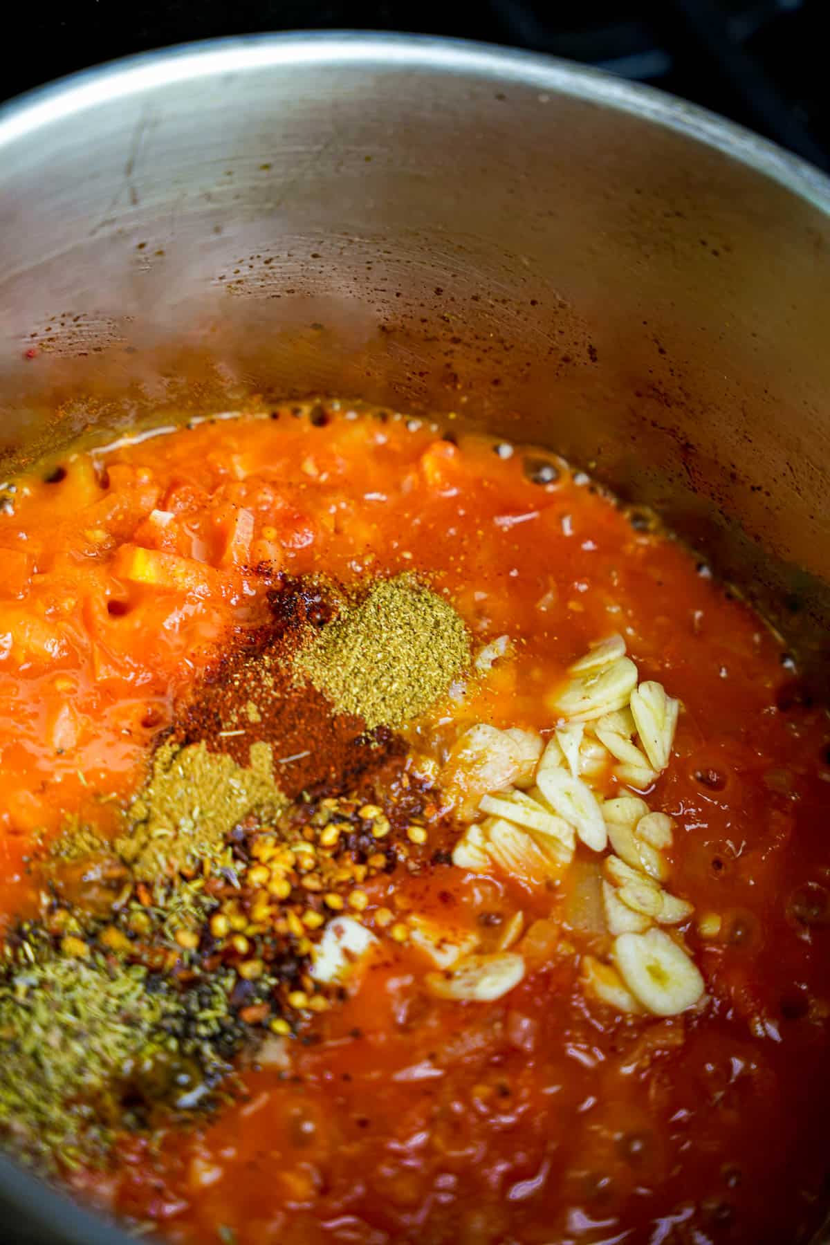 Garlic and spices are added to the coking sauce.