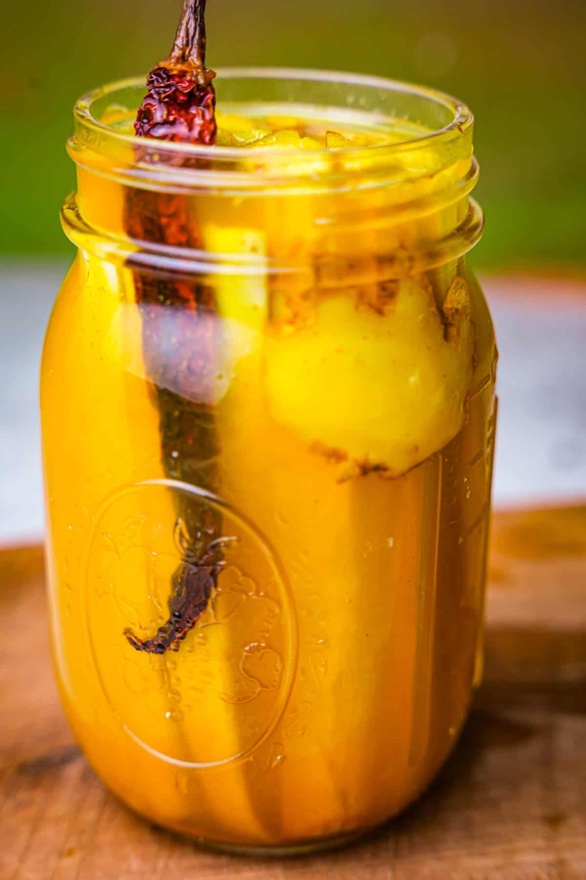 Chili and ginger slices are added to the jar with burdock strips.