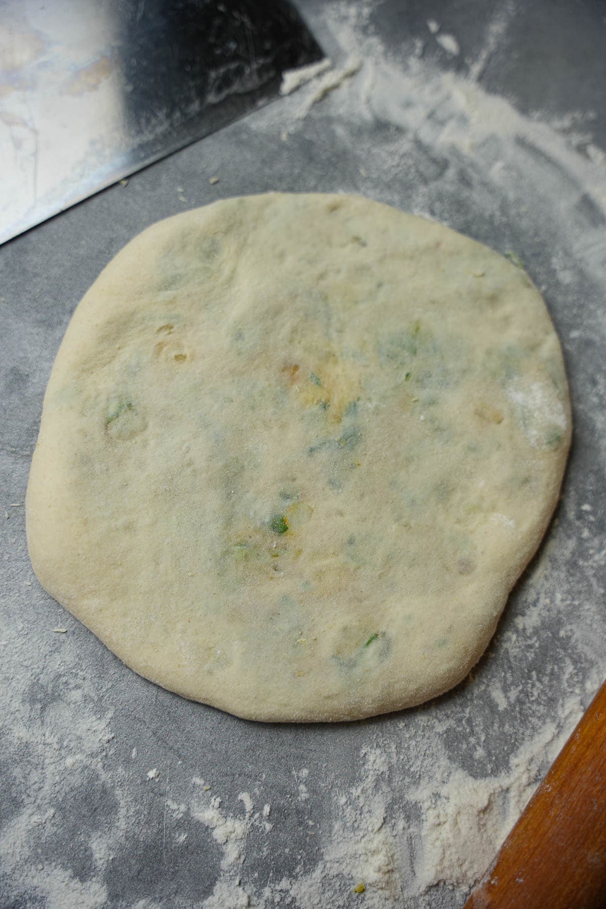 The filled dough. is re-rolled out into a 6-7 inch circle.