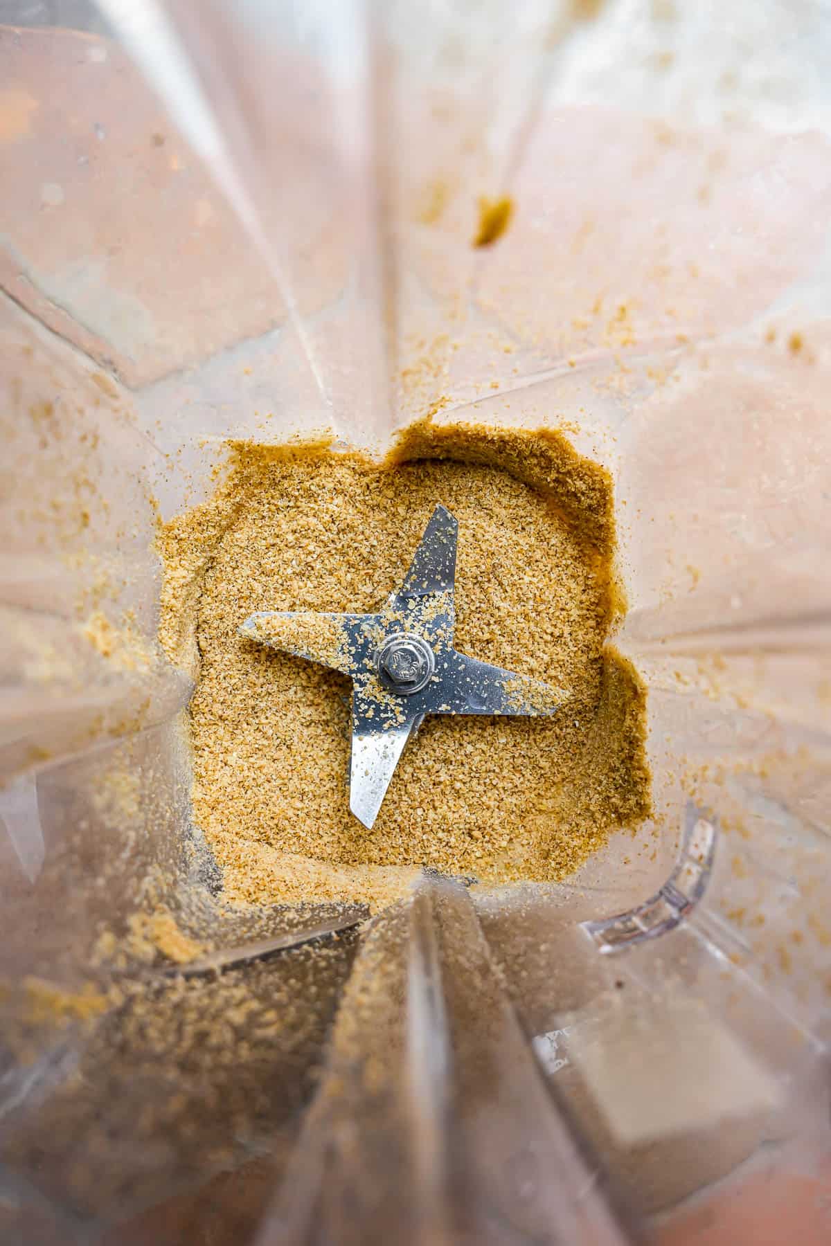 Sesame seeds are ground into a coarse meal in a blender.