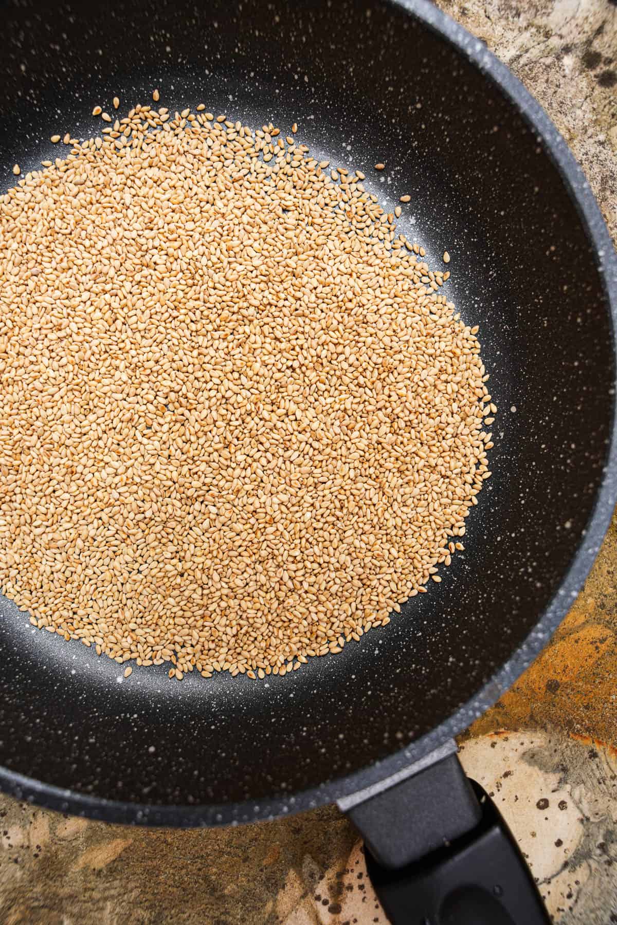 Sesame seeds lightly toasted in a non-stick sauté pan.