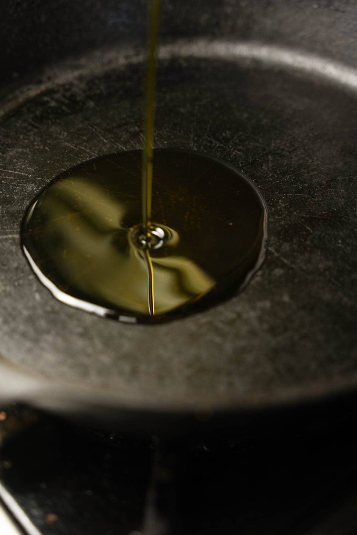 Oil is heated in a cast iron pan.