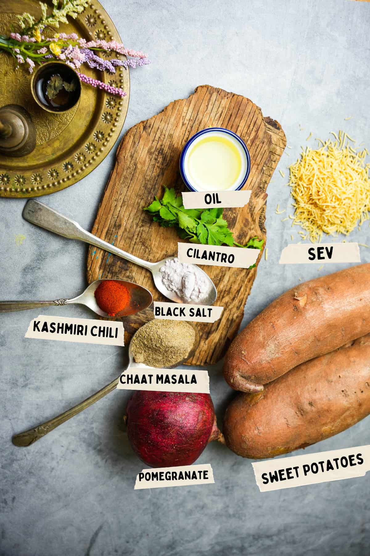Ingredients for making shakarkandi chaat are measured out and labeled on a stone countertop.