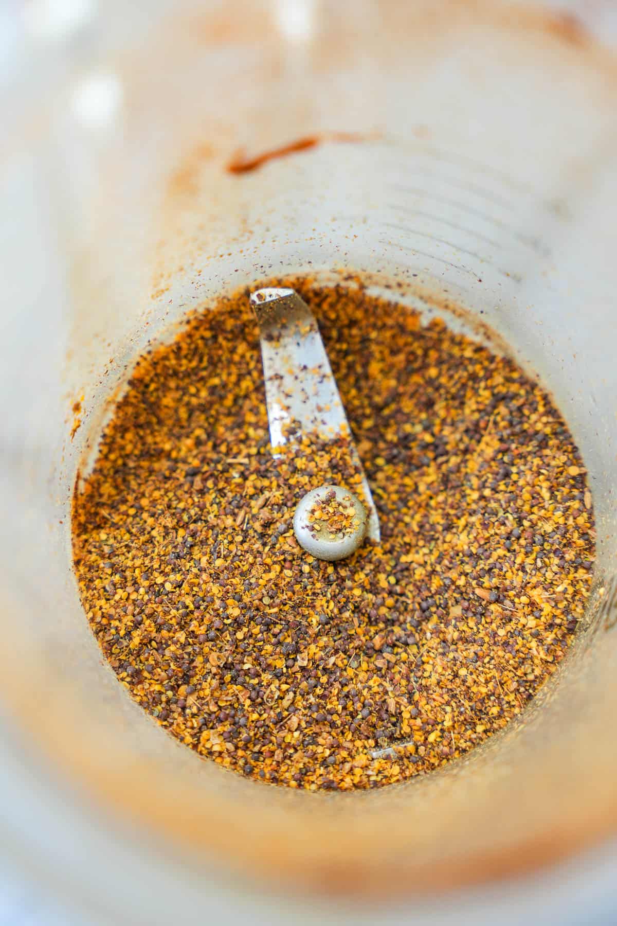 Spices are ground in a blender pitcher.