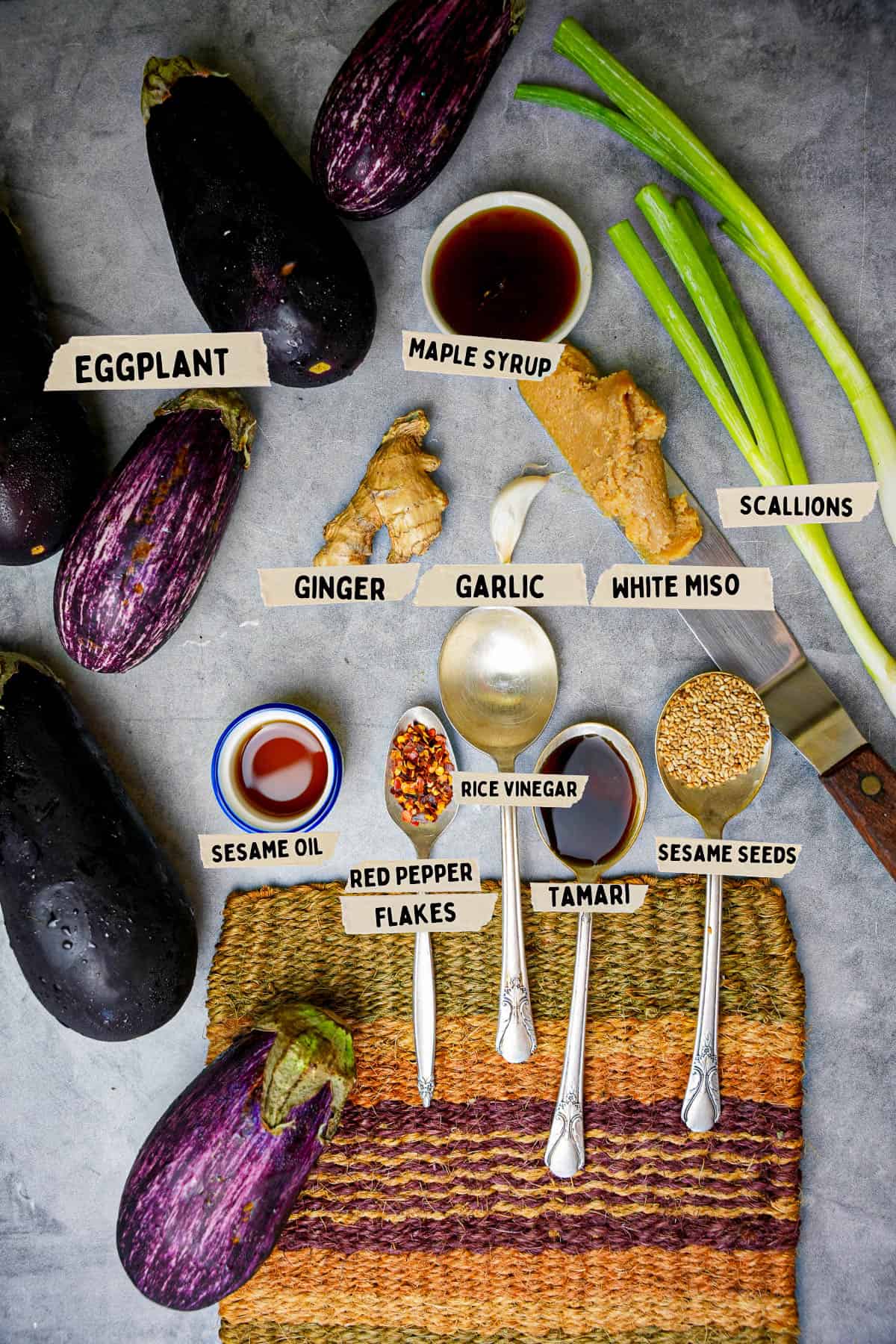 Ingredients for making miso glazed aubergine are measured out and labeled on a stone counter top.