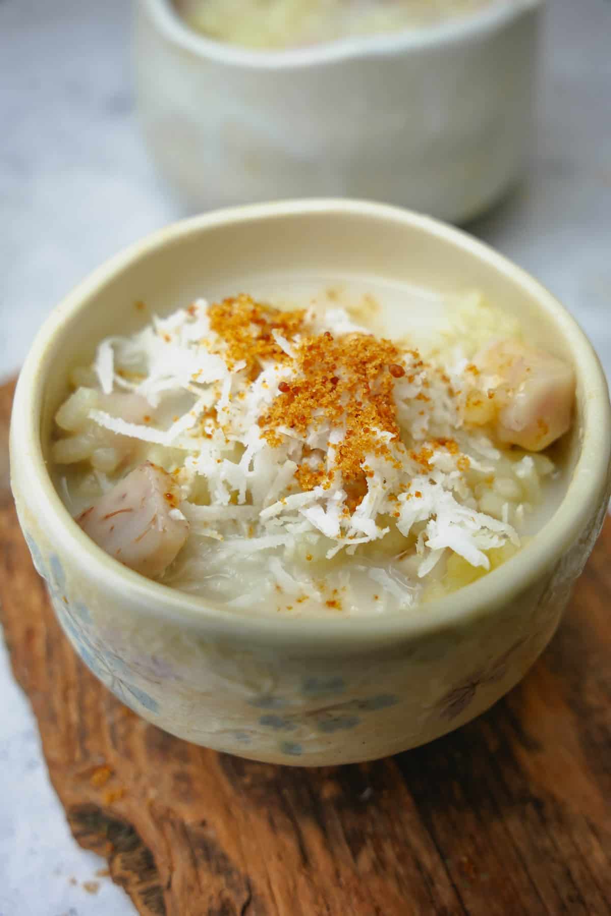 A bowl of che khoai mon topped with coconut and palm sugar.
