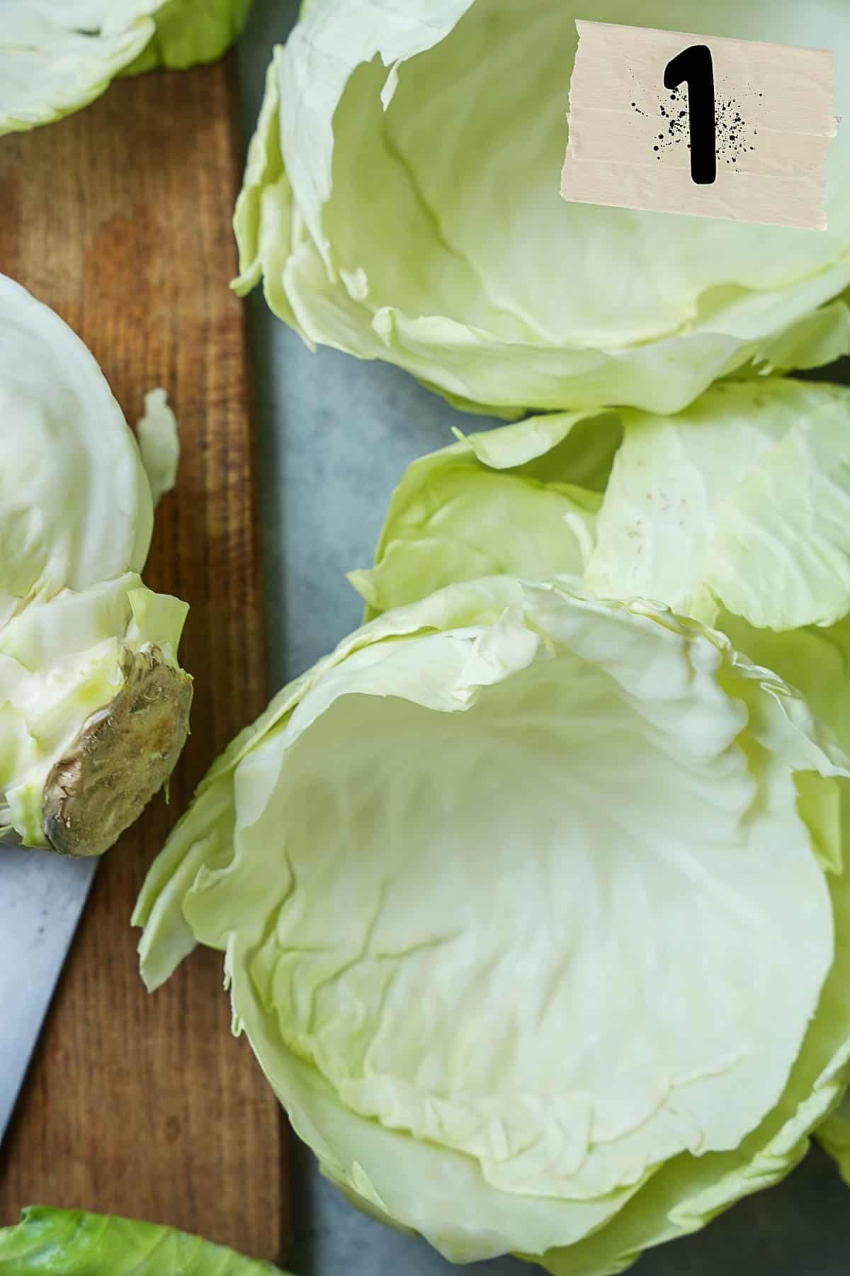 Cabbage leaves are removed one by one from the green cabbage.