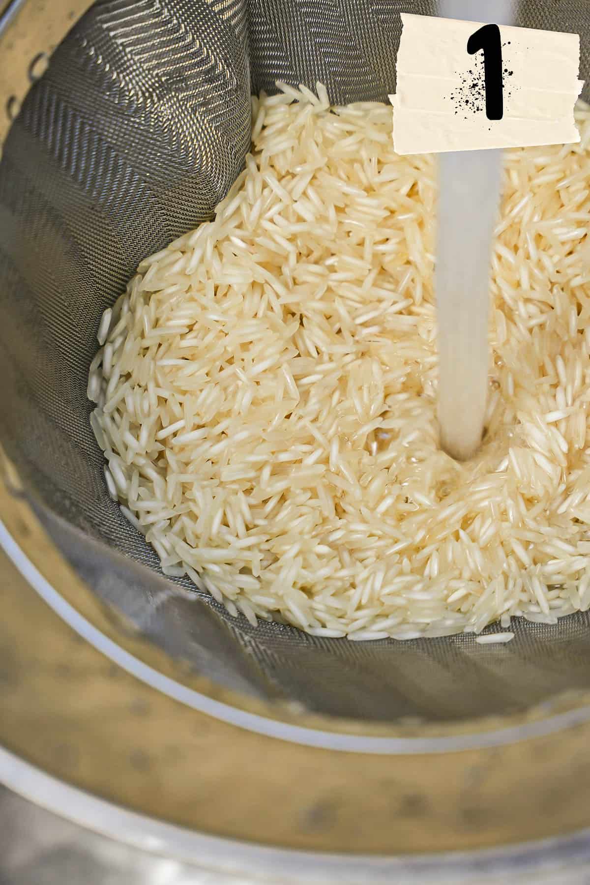 A strainer of rice is rinsed with cold running water.