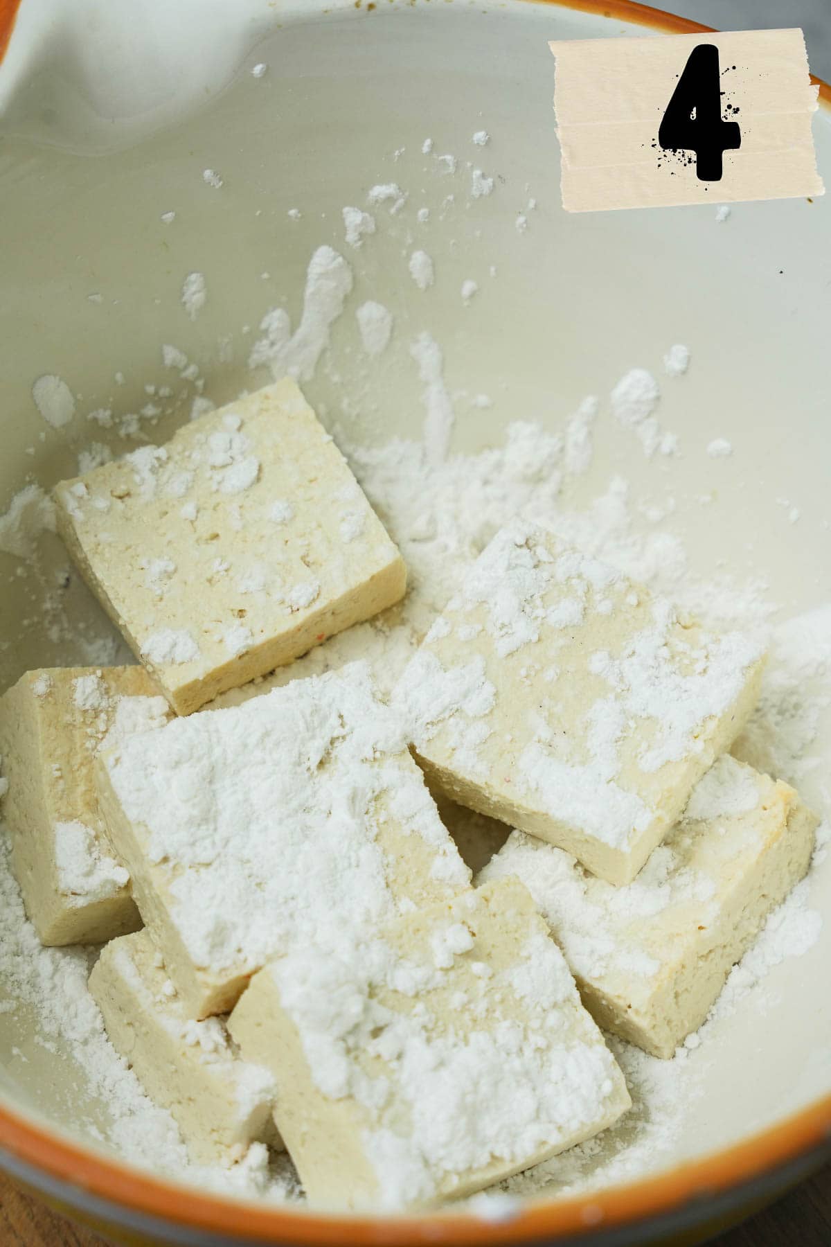 A bowl filled with tapioca flour and tofu.