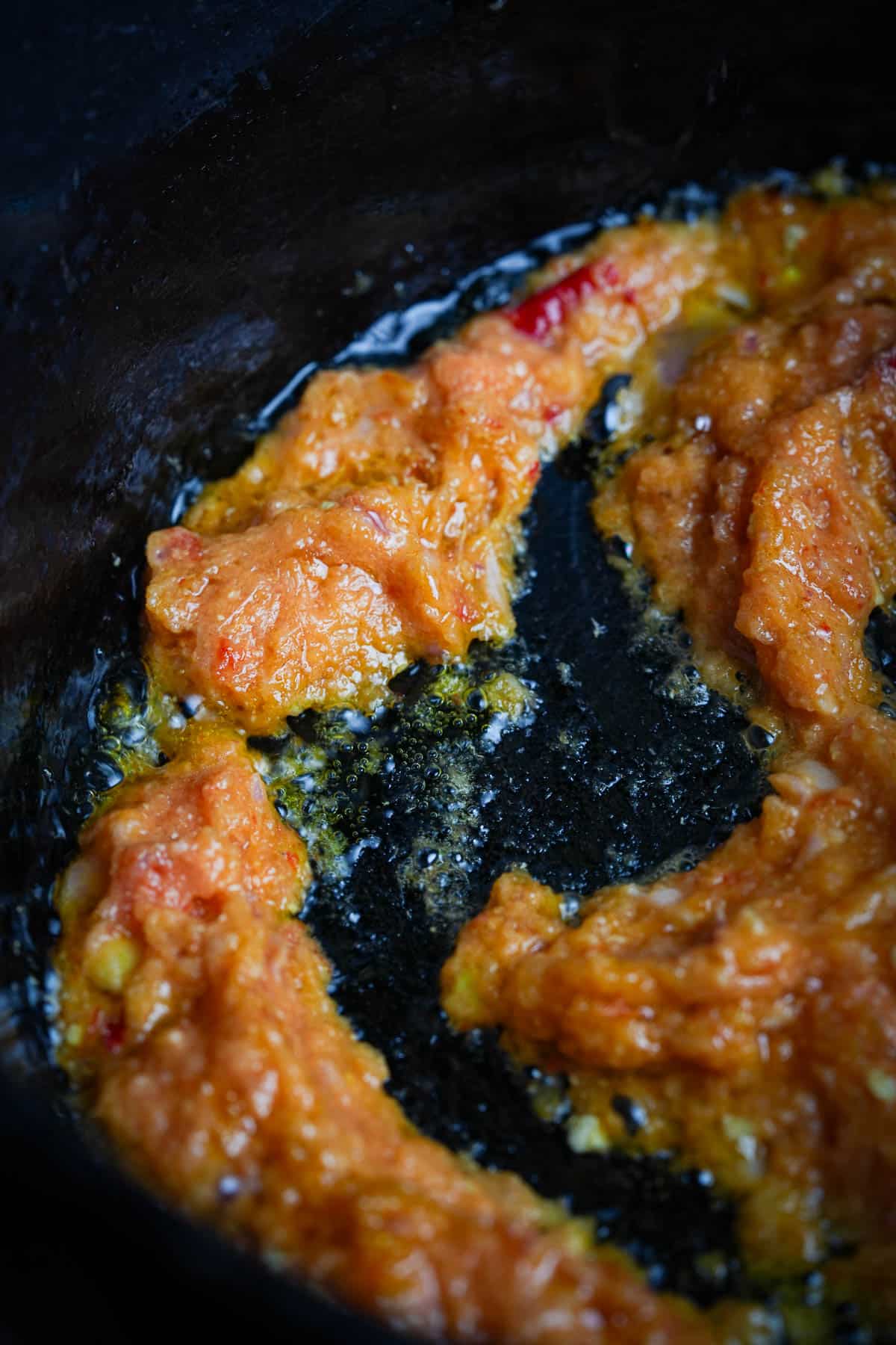 A frying pan with sambal frying in it.