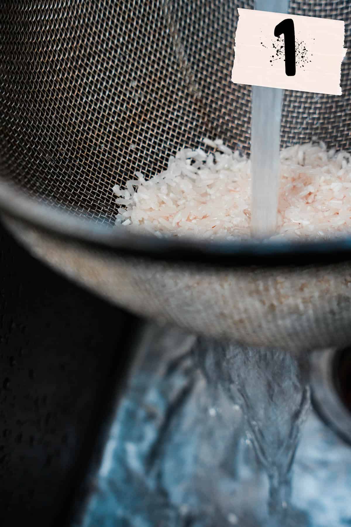 White rice is rinsed in a wire mesh strainer.