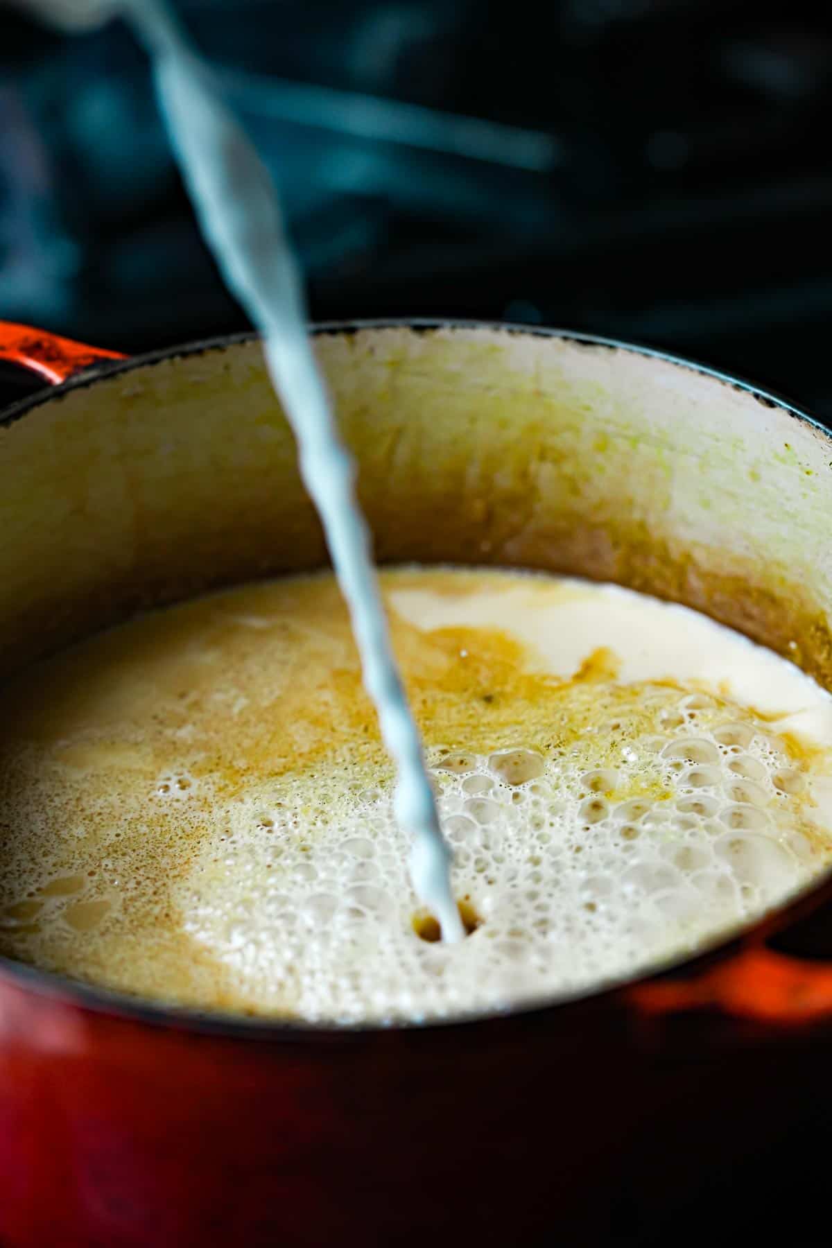 A pot with tapioca slurry being poured into it.