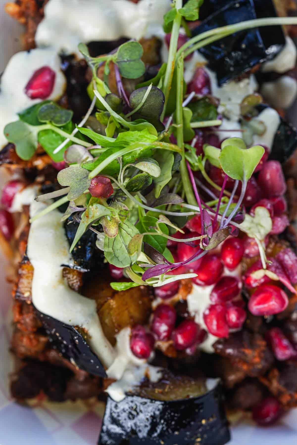 A plate of food with vegetables and pomegranate.