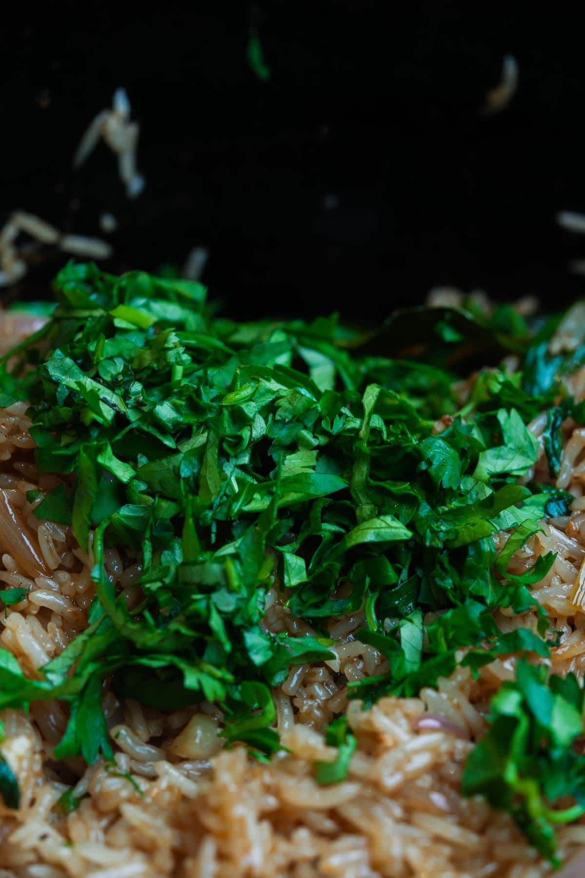 A pot with rice and herbs in it.