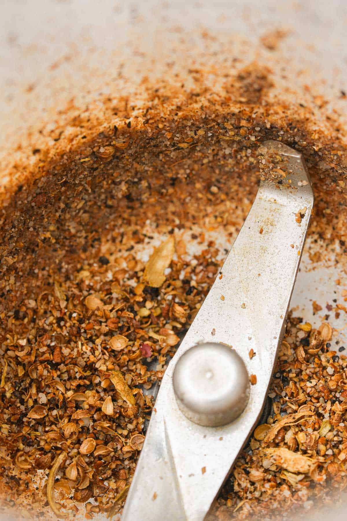 A blender is being used to grind spices.