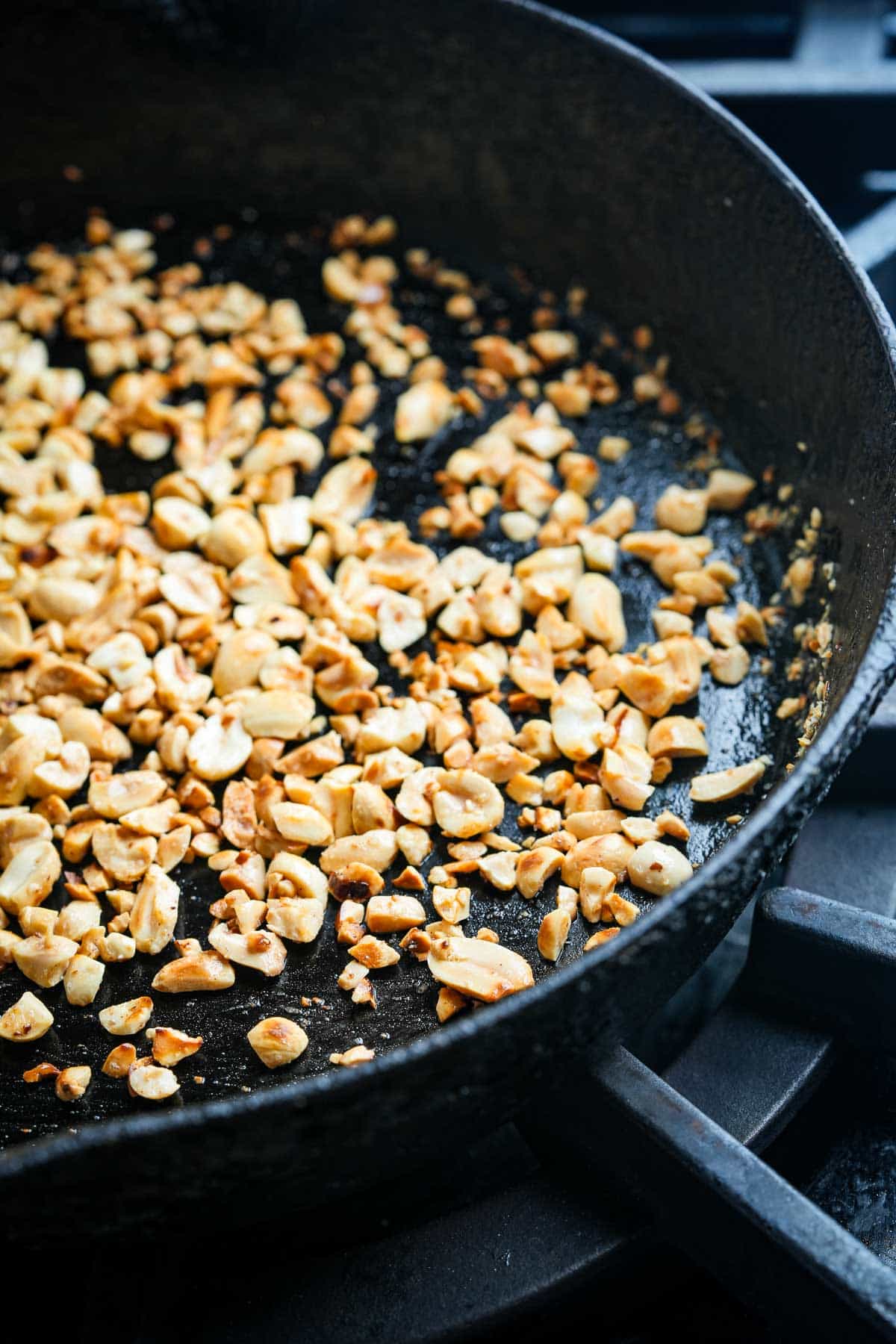 A frying pan with peanuts in it.