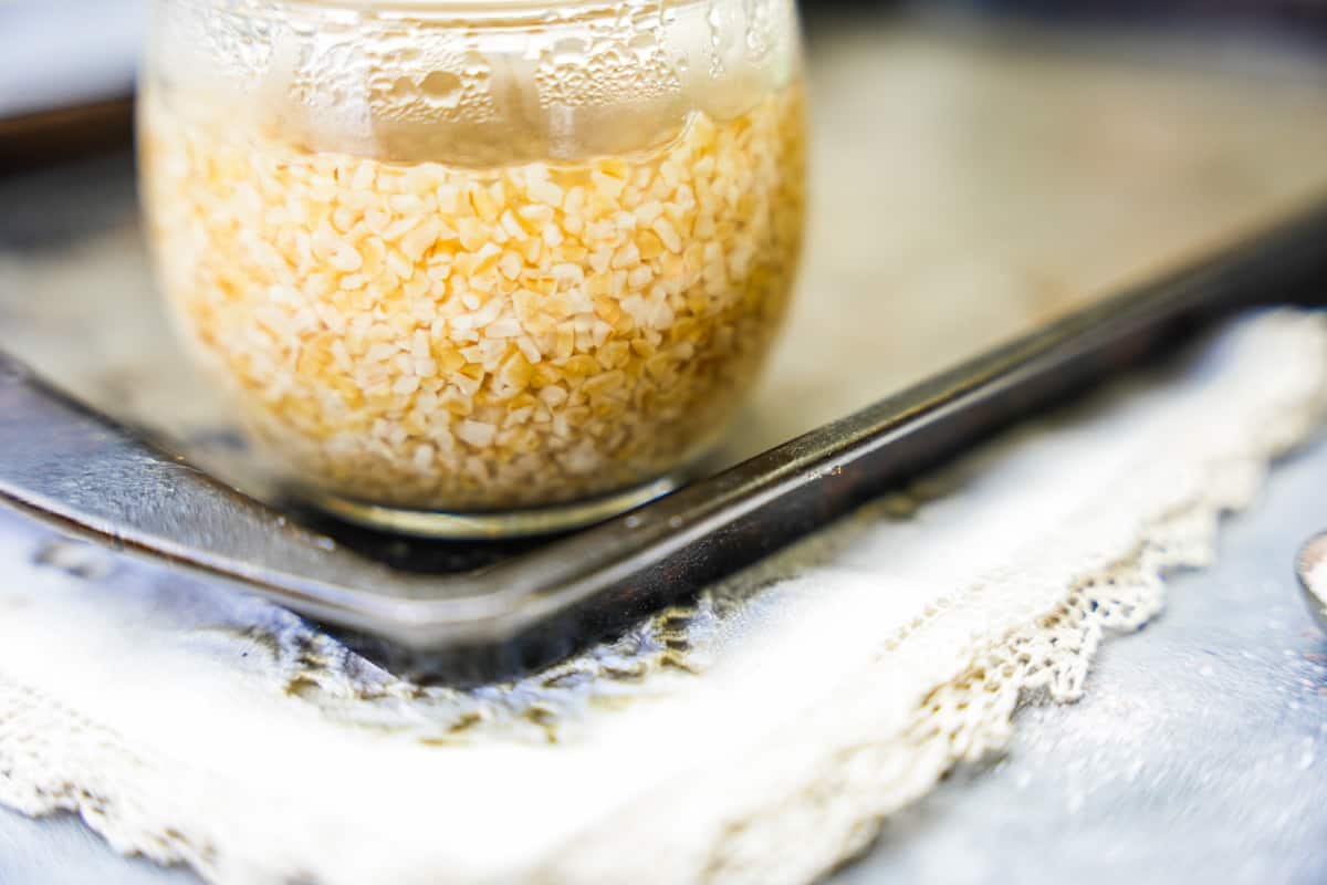 A glass full of bulgur that is fully hydrated and expanded.