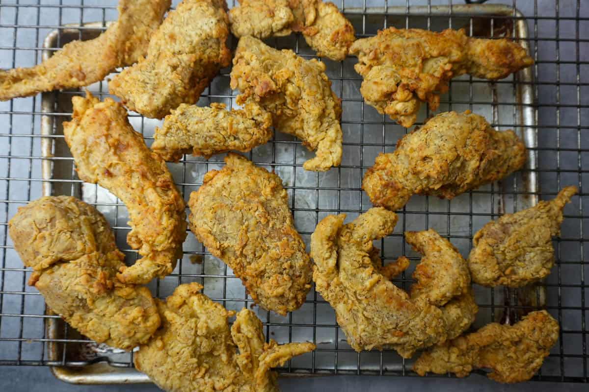 A tray of about 12 pieces of crispy Vegan Fried Chicken on a wire rack.