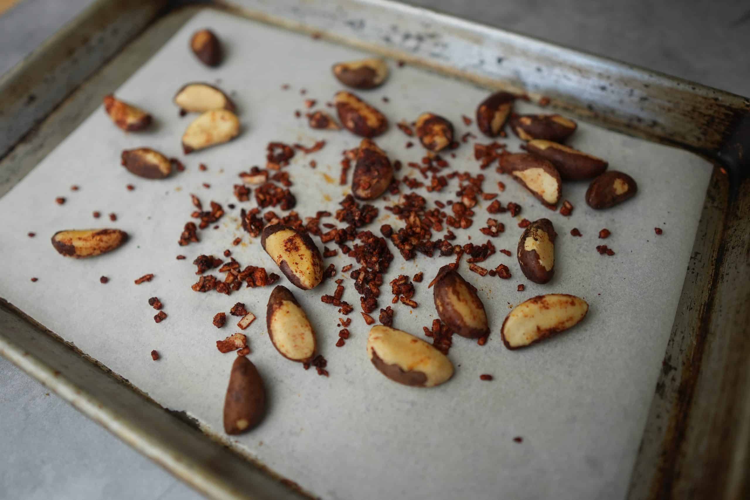 brazil nuts, garlic, paprika and oil mixed up and placed on a parchment paper lined baking tray.
