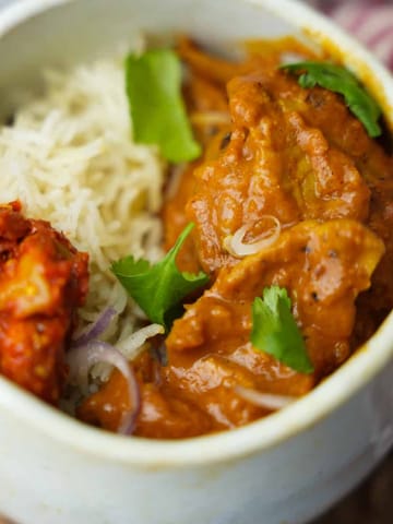 Vegan Butter Chicken in a bowl with basmati rice and pickle.