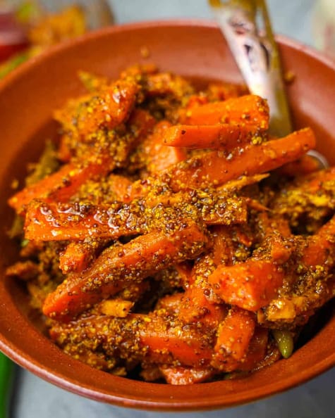 carrot pickle in an orange ceramic bowl,
