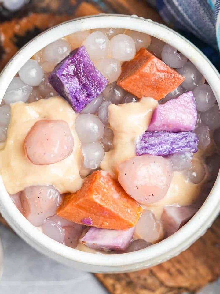 A bowl filled buber cha cha containing a variety of tapioca jellies, steamed root vegetables, and coconut porridge.