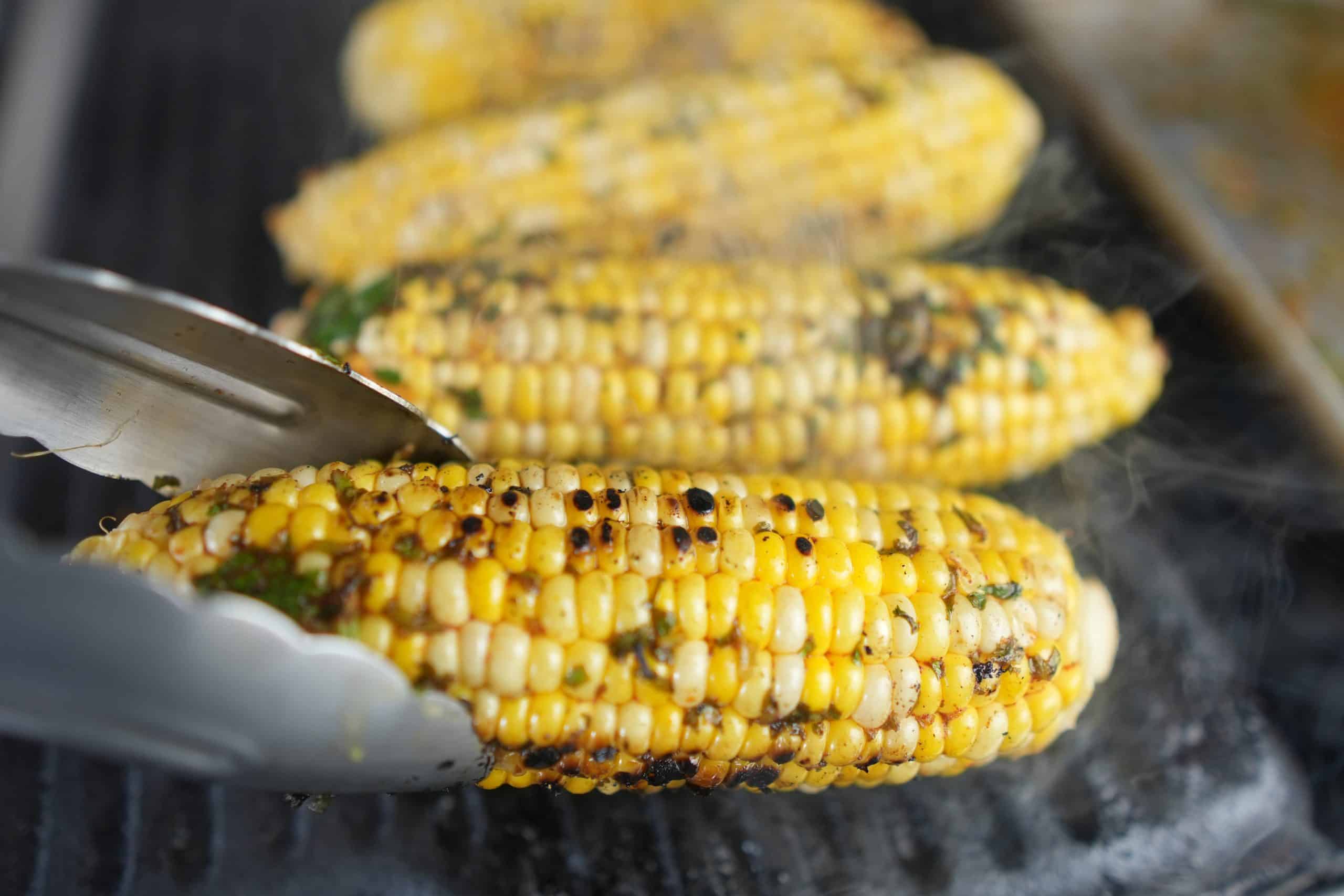 corn getting grilled showing char marks.