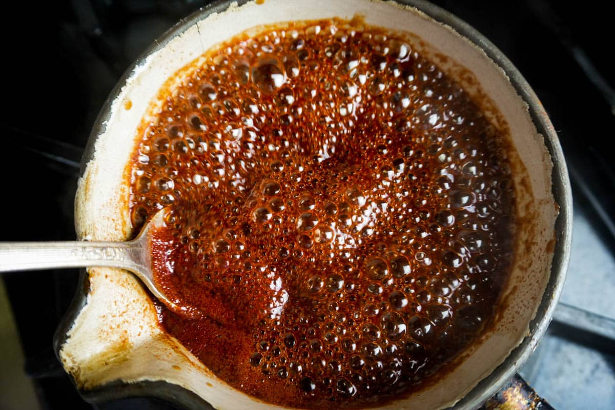 Tonkatsu sauce cooking. It's bubbling and thickening in a small saucepan