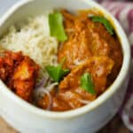 Vegan Butter Chicken in a bowl with basmati rice and pickle.