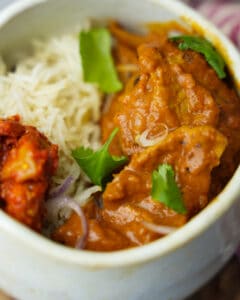 Vegan Butter Chicken in a bowl with basmati rice and pickle.