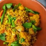 Vegan biryani in an orange bowl
