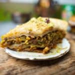 A serving of baklava is being served on a tony plate.