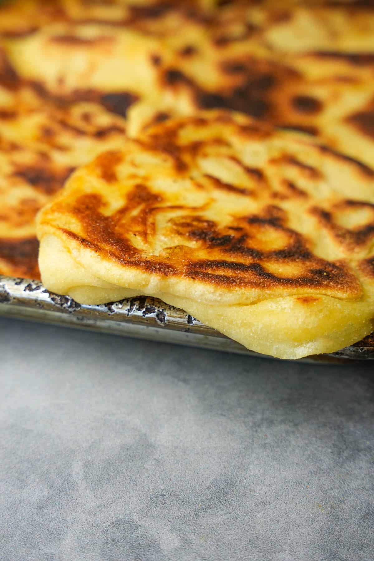 A metal sheet pan full of freshly baked Moroccan pancakes.