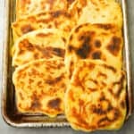 A metal sheet pan full of freshly baked Moroccan pancakes.