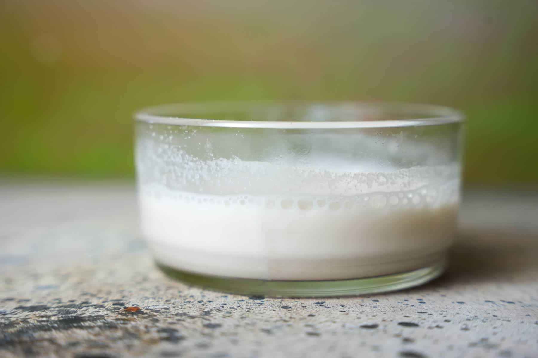 Cornstarch slurry is mixed in a glass bowl.