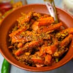 carrot pickle in an orange ceramic bowl,