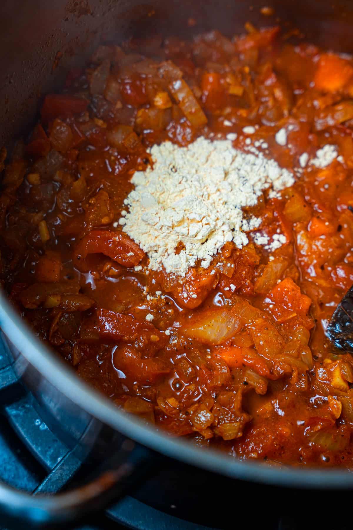 Besan (chickpea flour) is added to the curry base.