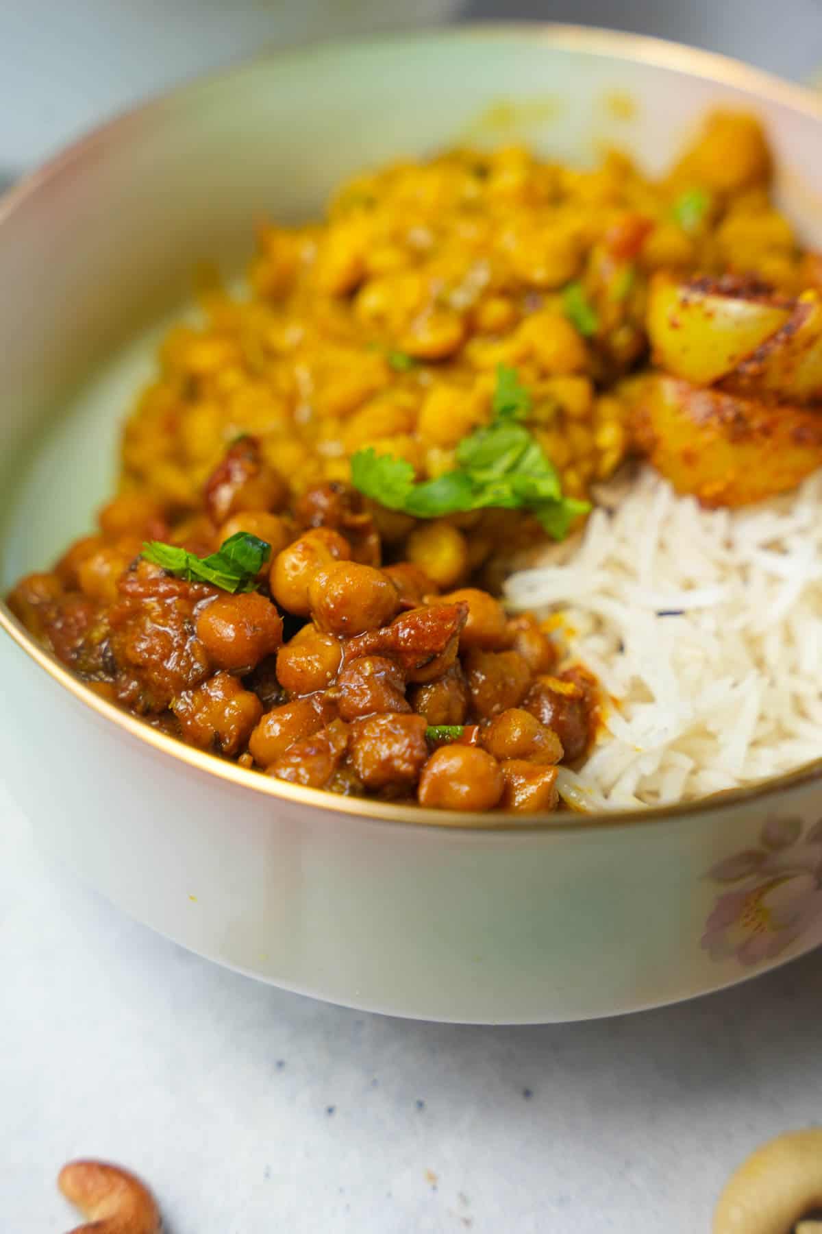 rice, chana dal, pickled amla and black chickpeas in a white bowl.