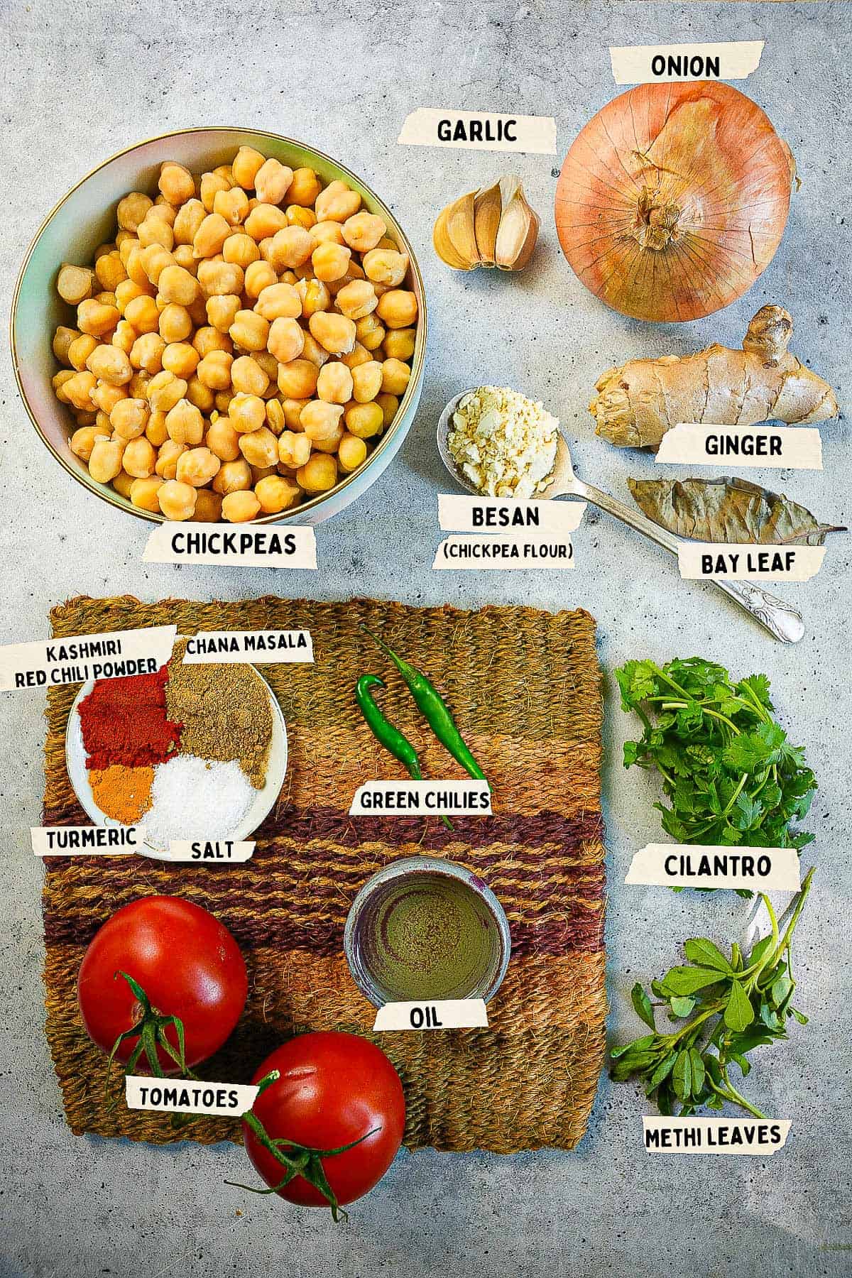 ingredients for a chana masala measured out and labeled on a table.