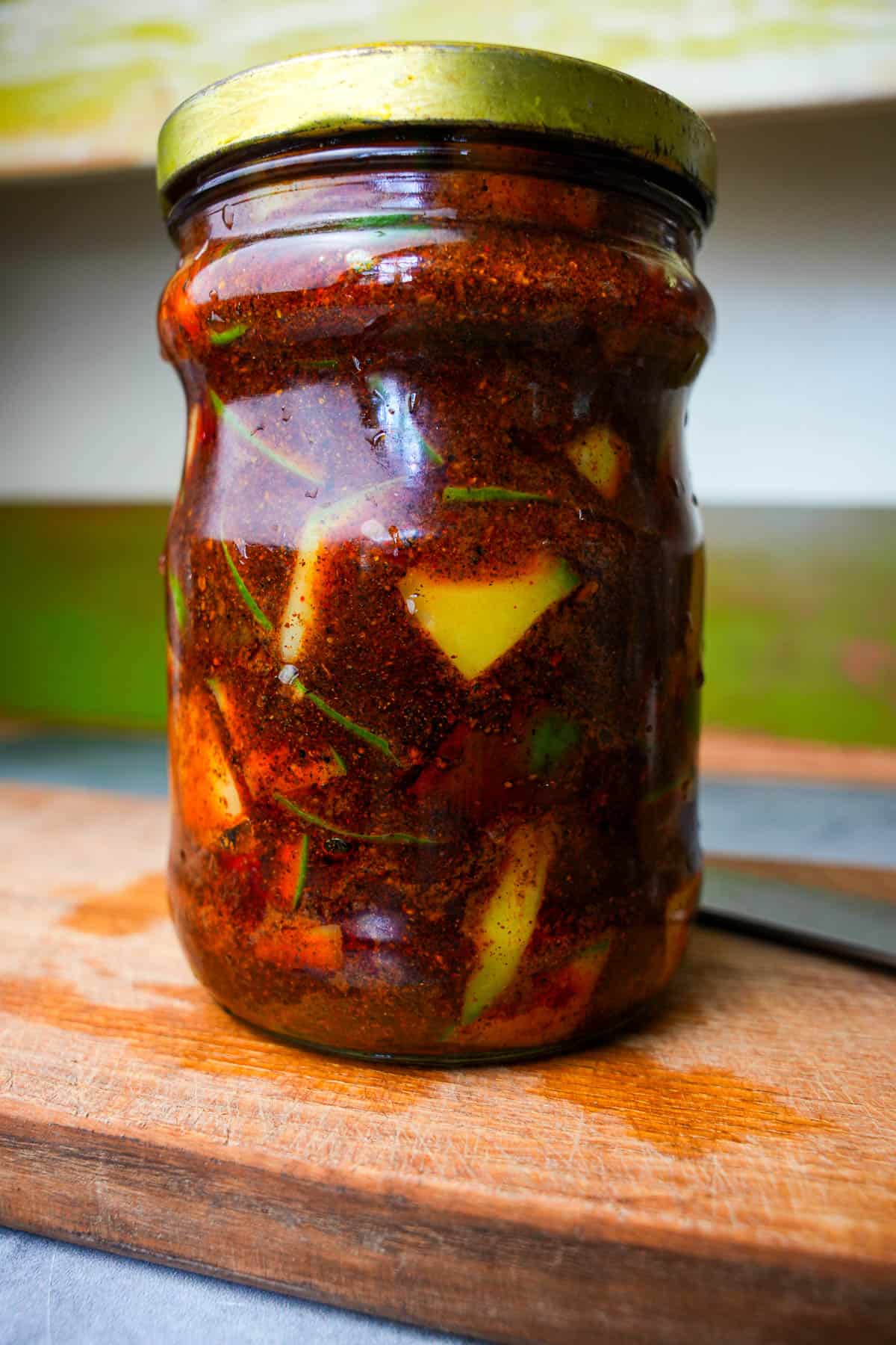 Mango pickle in a clean jar sitting out at room temperature for 24 hours.