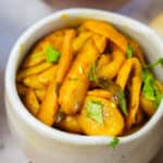 A white bowl of aloo parwal sabji.