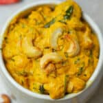 A bowl of pohool makhana curry with cashews.