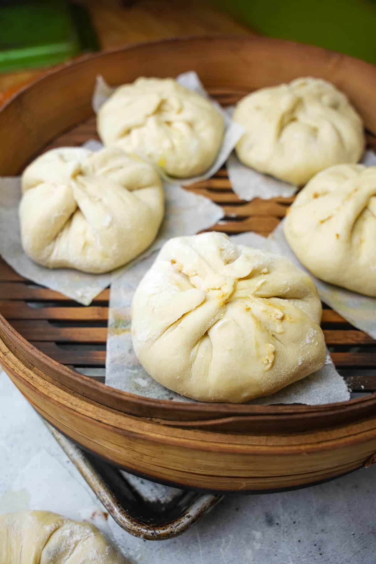 Formed bao in a bamboo steamer.