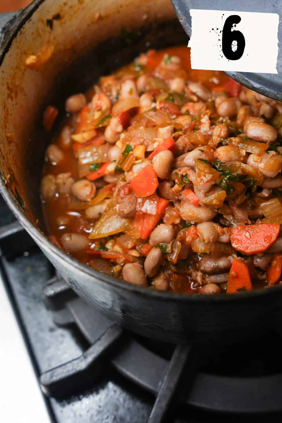 Beans, parsley, salt, sugar and water are added and a lid is put on