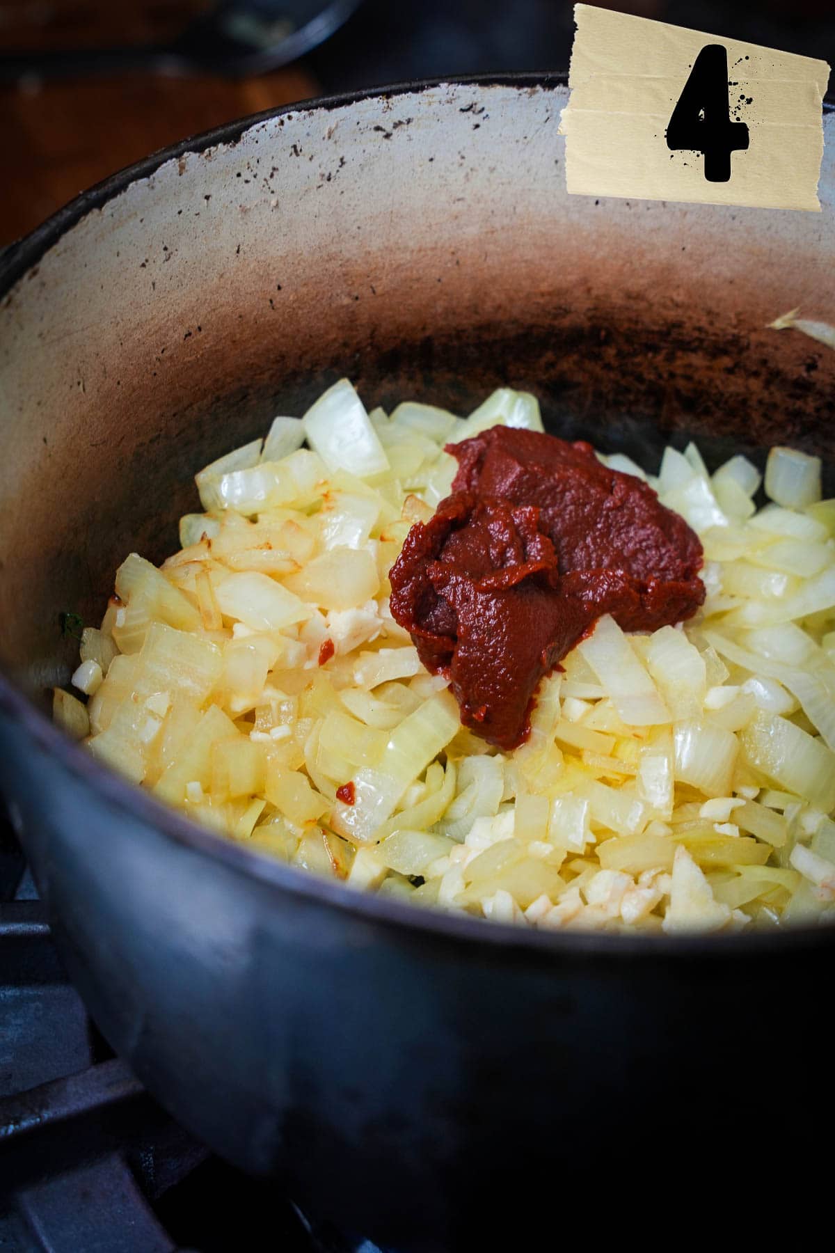 Turkish pepper paste is added to the pot with onions and garlic.
