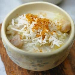 A bowl of che khoai mon topped with coconut and palm sugar.